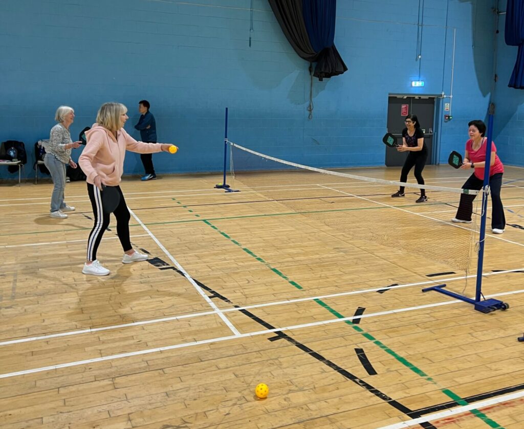 4 people playing pickleball